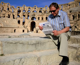 Al reading the OAPT Newsletter at the 3rd century Roman amphitheatre in El-Jem, Tunisia, in 2007